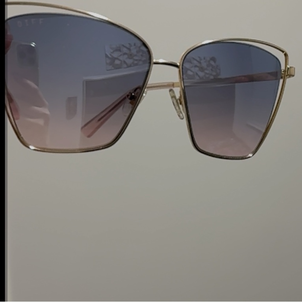 Gold oversized cat-eye sunglasses with metallic frame and gradient lenses